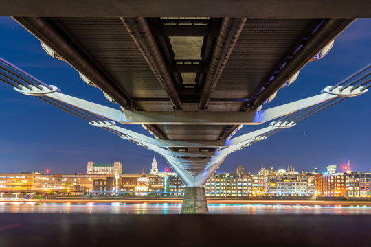 Millennium Bridge with skyline of the city, London, UK