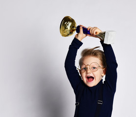 Little boy celebrates his golden trophy