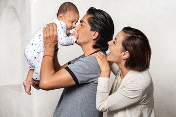 Young parents enjoying their newborn. Love and affection for their child