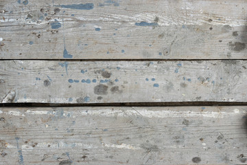 Fototapeta na wymiar Old gray-brown natural wood background in the form of a board with cracks, knots and a rough surface