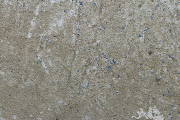 Old gray concrete wall with yellow and brown spots as an abstract background