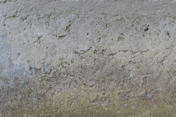 Old gray concrete wall with yellow and brown spots as an abstract background