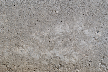 Old gray concrete wall with yellow and brown spots as an abstract background