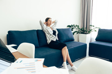 Young adult woman resting at home after work