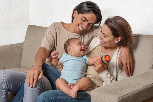 Parents Are Proud And Look Together Of Their Newborn Baby