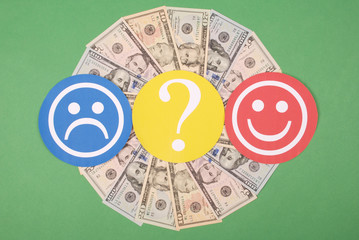 Question mark between smiley and sad smiley on mandala kaleidoscope from money.