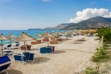 Fototapeta na wymiar Empty deck chairs by the sea. Under a canopy. Borsh Albania