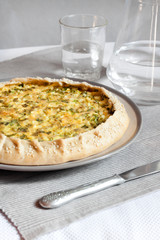 Tart with eggs and green onions on a plate