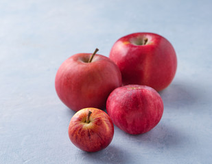 fresh red apples on blue wood table autumn garden copy space close up