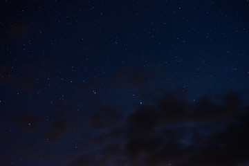 Fototapeta na wymiar Stars in the night sky through the clouds