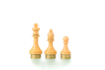 Conceptual photo with chess pieces and coins showing the concept of social equality.