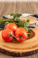 fresh tomatoes and parsley on wood  