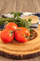 fresh tomatoes and parsley on wood  