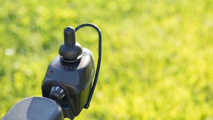 wheelchair joystick with Grass background © Hector