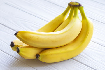 Ripe natural bananas on a wooden table © Frank Parker