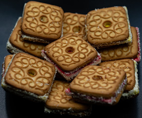 Tasty biscuits with filling on a plate