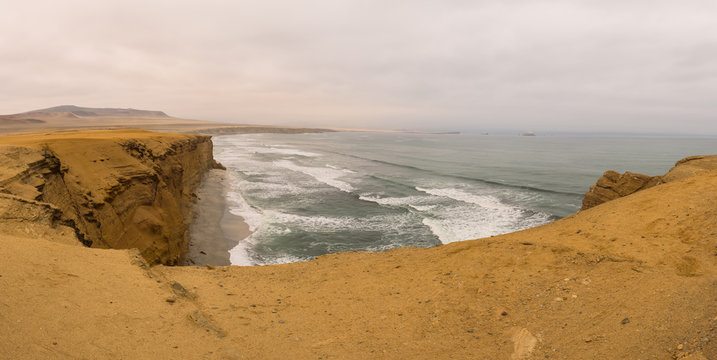 Dramatic coastline with intense colors in the desert of Paracas National Reserve, Peru