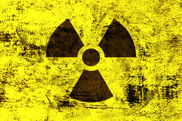 Radioactivity symbol on yellow grunge background - obrazy, fototapety, plakaty