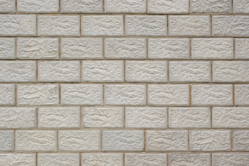 Wall of a house made of gray concrete blocks. Background image