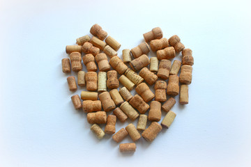 Heart-shaped wine stoppers on a white table. Top view with copy space for text