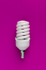 classic energy-saving white lamp, with efficient power use, isolated on color background