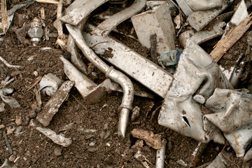 Detail of scrap metal on the ground of a junkyard. 