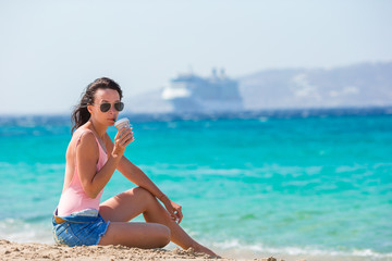Fototapeta na wymiar Young beautiful woman with coffee on the beach during tropical summer vacation