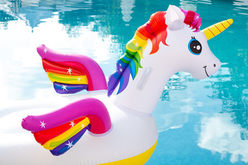 Head of unicorn inflatable pool float. Summer holidays, beach vacation. Fantasy swim ring. Pride