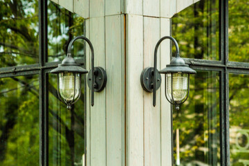 metal street lamps on the facade of the building in a row on a blurry background in the daytime
