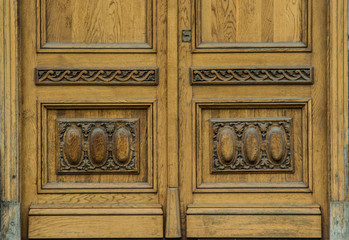 beautiful vintage solid wood door with carved patterns and a gold vintage handle