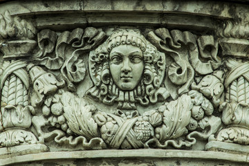 Fototapeta na wymiar textured vintage bas-relief on the facade of the building close-up during daylight hours