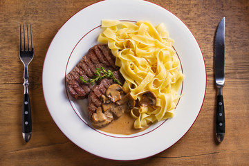 Beef steak and pasta with creamy mushroom sauce