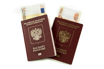 Two Russian passports with banknotes five thousand rubles and euros on a white background. Traveling abroad to Europe, tour package, family.