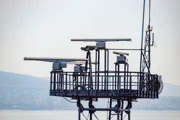 Rotating antennas of a military radio station on tower.