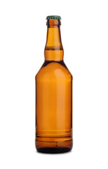 Brown glass bottle of beer with metallic cap isolated on white background.