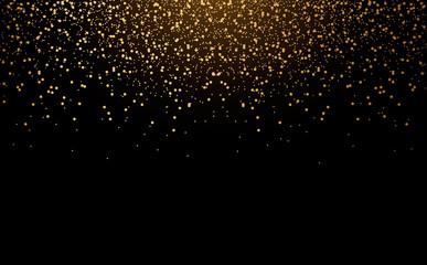 Golden scattered dust powder falling from above with shine on a black background.