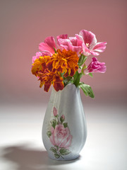 Ceramic vase with flowers on a colored background