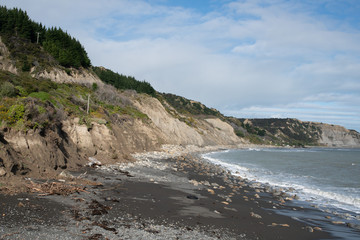 Fototapeta na wymiar Crumbling limestone cliffs due to erosion at the coast