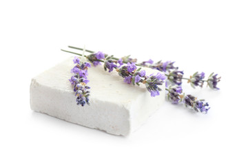 Obraz na płótnie Canvas Hand made soap bar with lavender flowers on white background