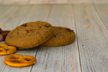 Baked oatmeal cookies and bagel lie on a light wooden table. There is a place for text. Concept breakfast, holiday, cooking.