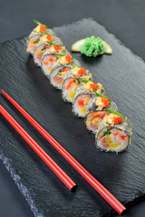 sushi rolls served on stone plate