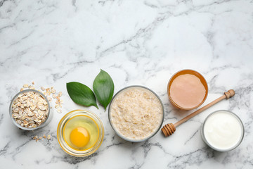 Handmade face mask and ingredients on white marble table, flat lay. Space for text