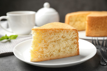 Piece of delicious fresh homemade cake on grey marble table