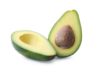 Halves of ripe avocado with pit on white background