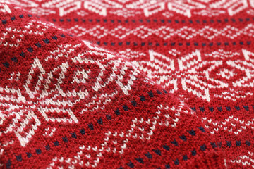 Warm Christmas sweater with snowflakes as background, closeup