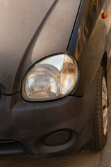 Leftist front wheel and headlight. Replicas of Russian cars. Halogen lighting at the black car.