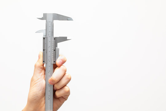Closeup view of a female hand holding an open engineering caliper, metal hand tool used to precisely measure, isolated on white background with room for copy.