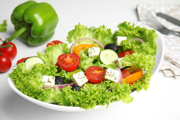 Tasty fresh Greek salad on white table, closeup