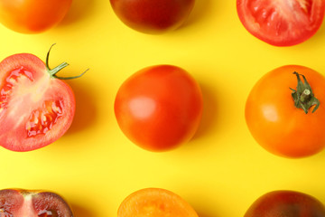 Flat lay composition with fresh ripe tomatoes on yellow background