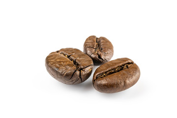 Three shiny fresh roasted coffee beans isolated on white background. Coffee background or texture concept.